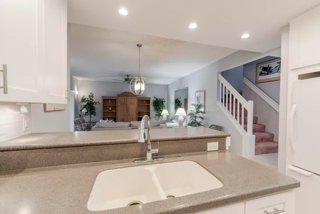 a view of living room with furniture and a chandelier