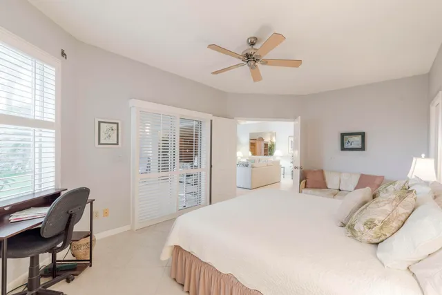 a bedroom with a large bed and wooden floor