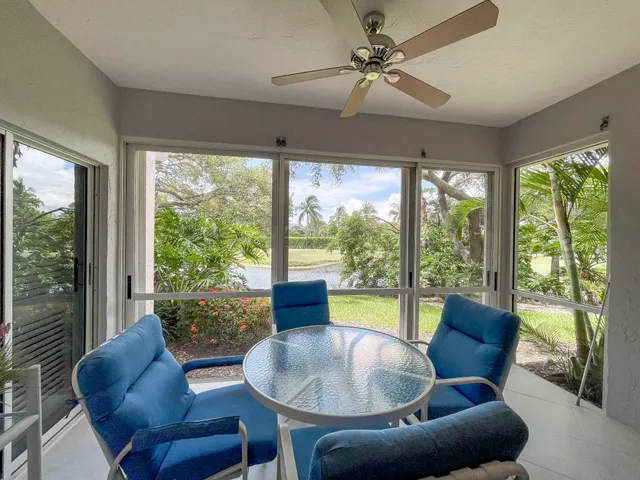 a living room with couch and a floor to ceiling window