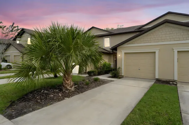 a front view of a house with a yard and garage