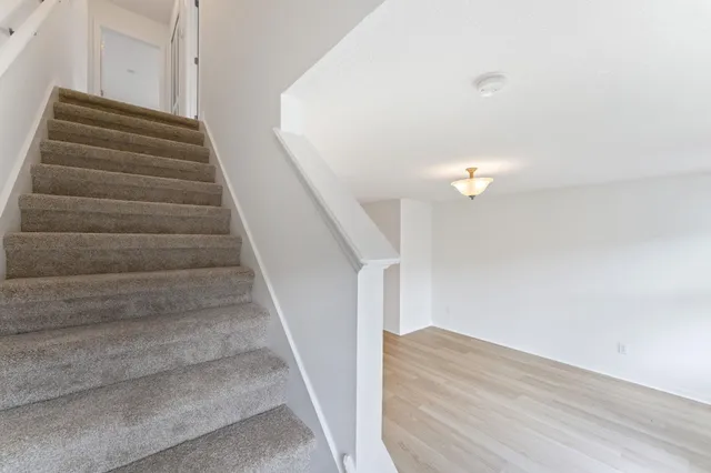 an empty room with closet and wooden door