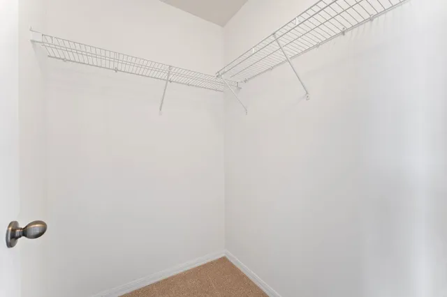 an empty room with a painting on the wall