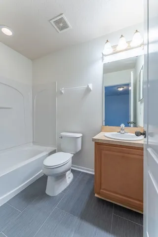 a bathroom with a sink a toilet and a bathtub
