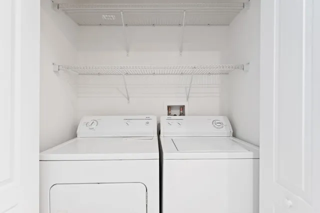 a view of a park with of a house in the background