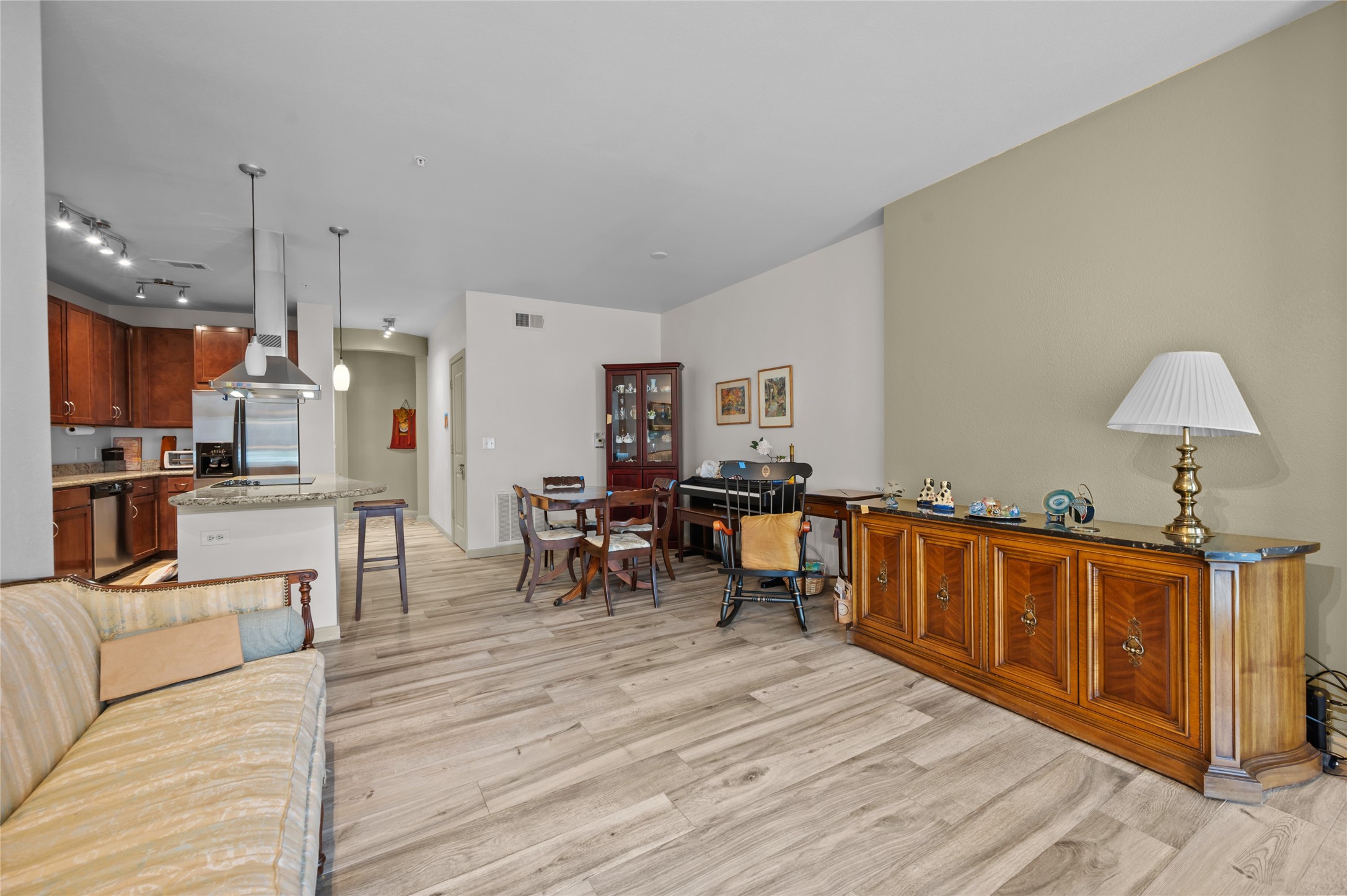 505 Jackson Hill Street, Unit 206 Houston, TX 77007 - Photo 13 of 35 a living room with furniture a dining table and chairs with wooden floor