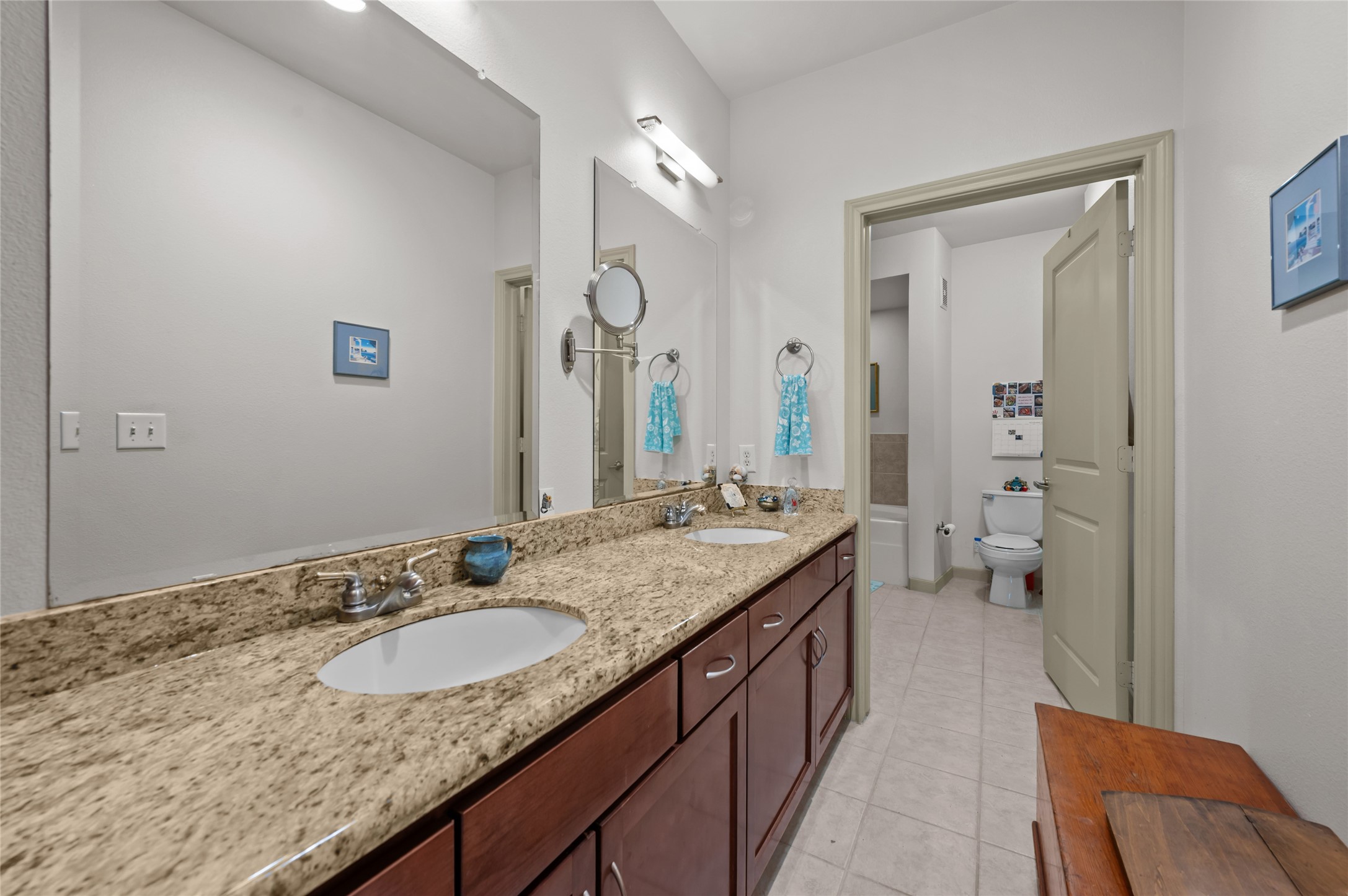 505 Jackson Hill Street, Unit 206 Houston, TX 77007 - Photo 20 of 35 a bathroom with a granite countertop sink and a mirror