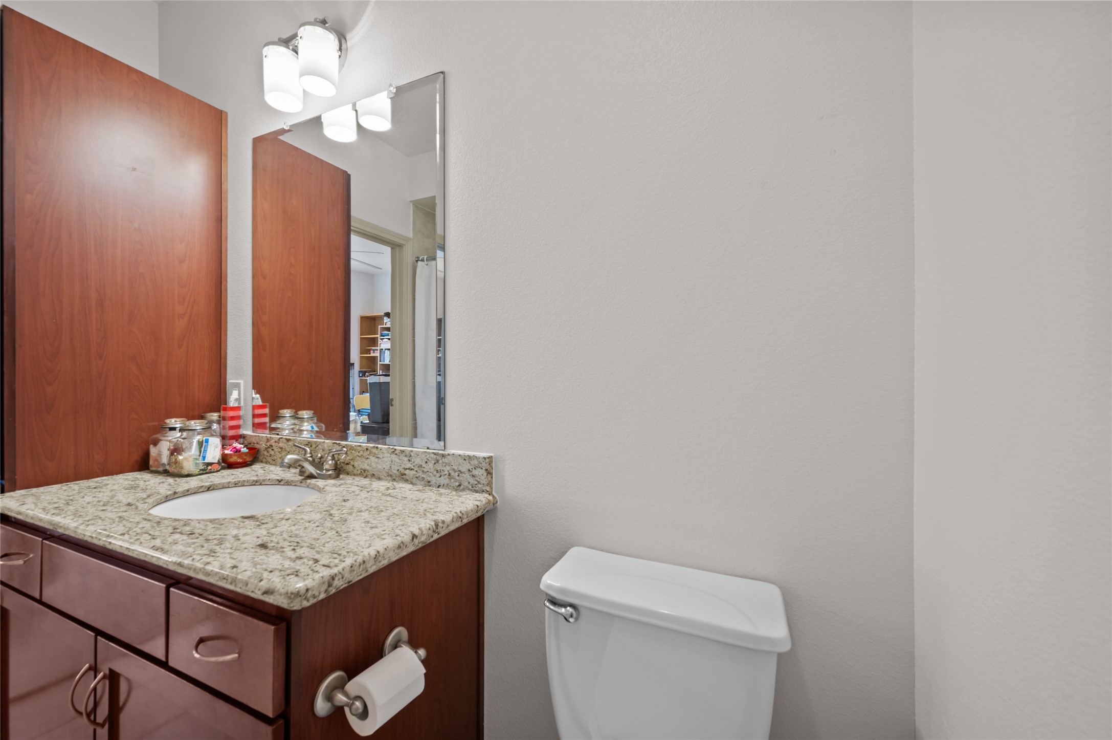 505 Jackson Hill Street, Unit 206 Houston, TX 77007 - Photo 23 of 35 a bathroom with a granite countertop sink and a mirror