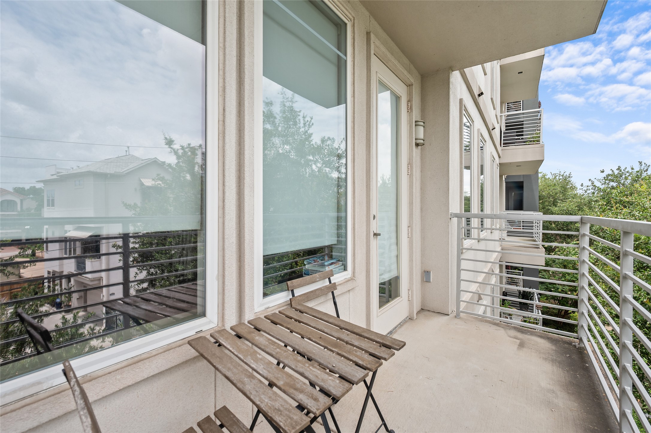 505 Jackson Hill Street, Unit 206 Houston, TX 77007 - Photo 31 of 35 a view of a balcony with wooden floor and windows