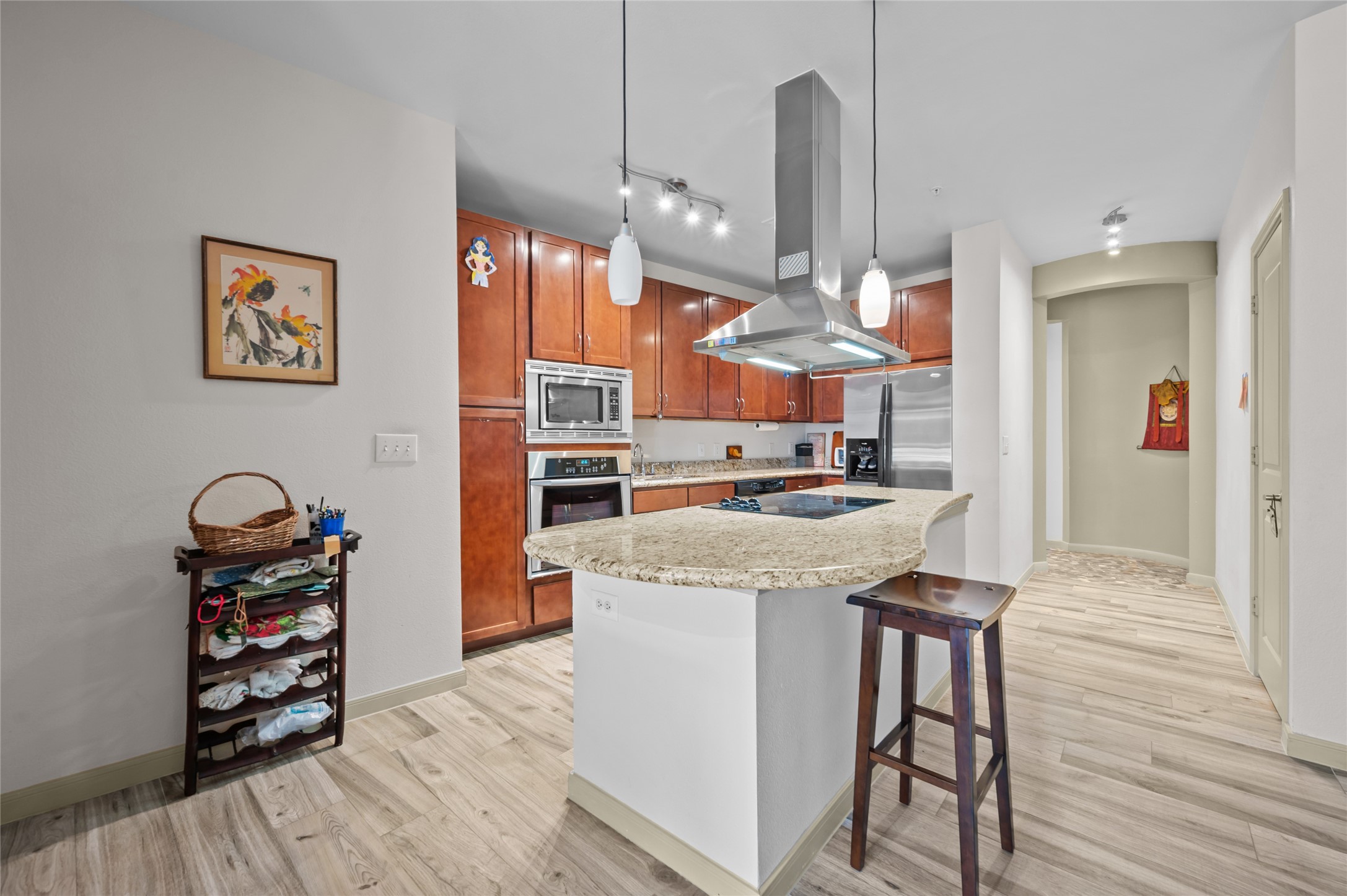 505 Jackson Hill Street, Unit 206 Houston, TX 77007 - Photo 10 of 35 a kitchen with stainless steel appliances granite countertop a stove and a wooden floors