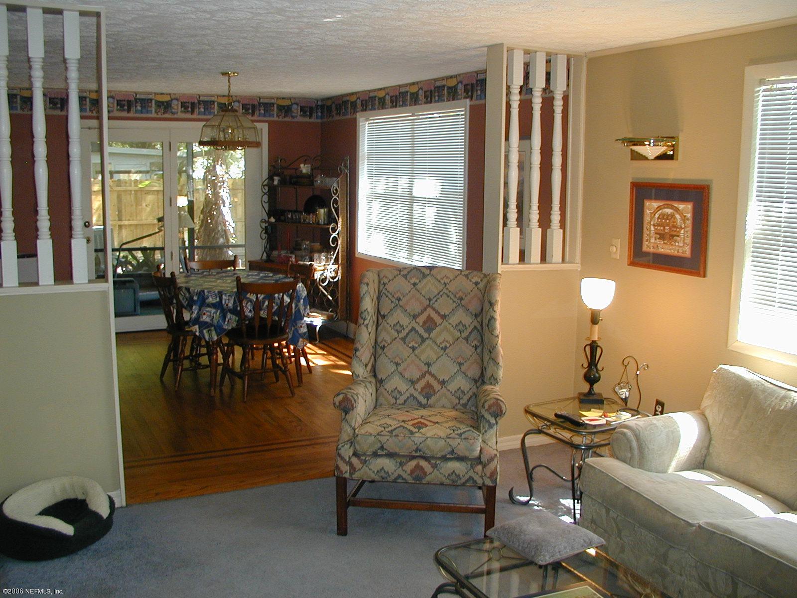5343 Stetson Road Jacksonville, FL 32207 - Photo 3 of 8 a living room with furniture a lamp and a potted plant