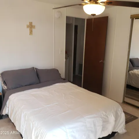 a large bed in a bedroom next to a bathroom