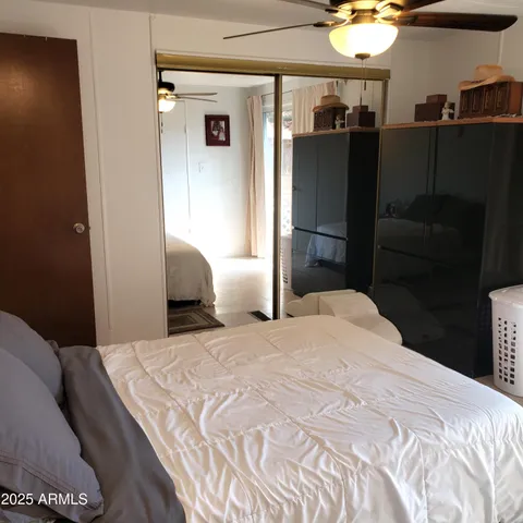 a bedroom with a bed and dresser with mirror