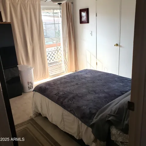 a bed sitting in a bedroom next to a window