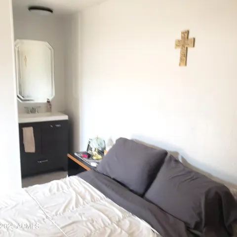 a bedroom with a bed and a mirror