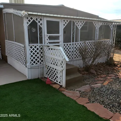 a view of a wooden door with a fence