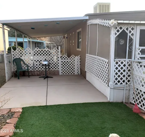 a view of a house with a wooden fence