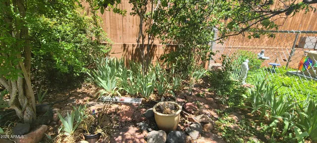 a backyard of a house with lots of green space and a fountain
