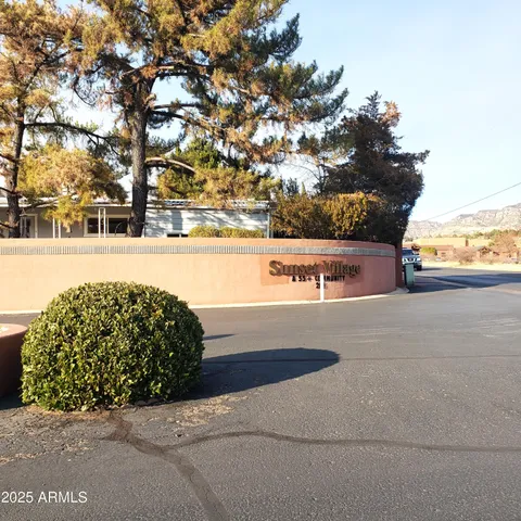 a view of swimming pool with outdoor seating and trees