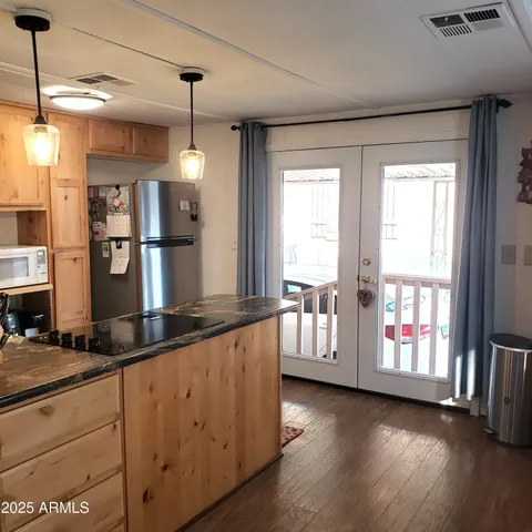 a kitchen with counter top space and wooden floor