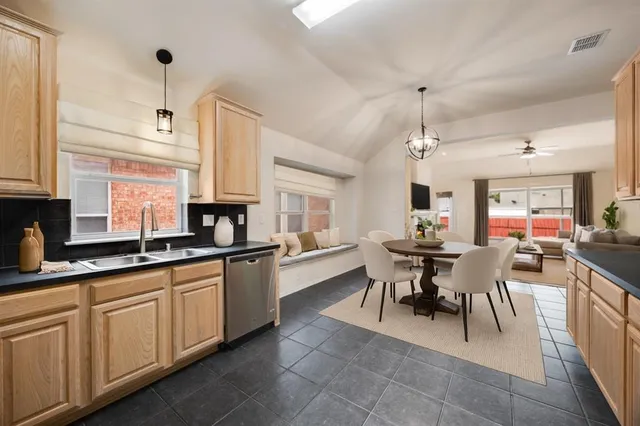 a large kitchen with a table and chairs
