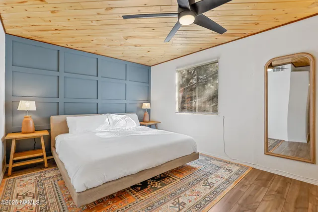 a bed sitting in a bedroom next to a window