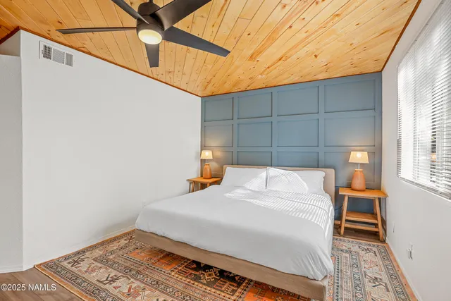 a bed sitting in a bedroom next to a window