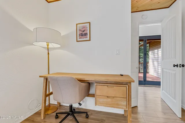 a view of a room with furniture and wooden floor