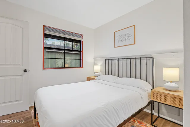 a bedroom with a bed and a window