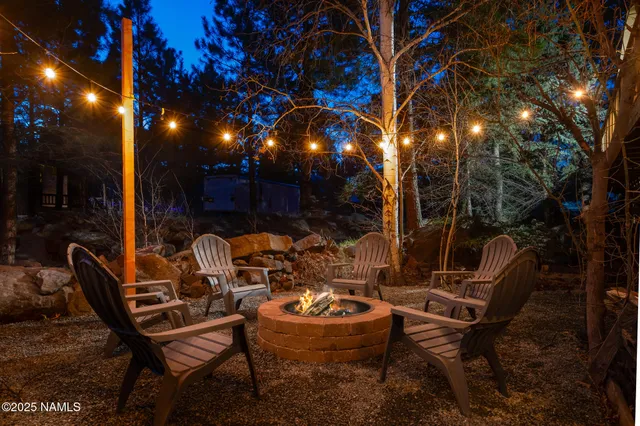 a view of a patio with table and chairs and wooden fence