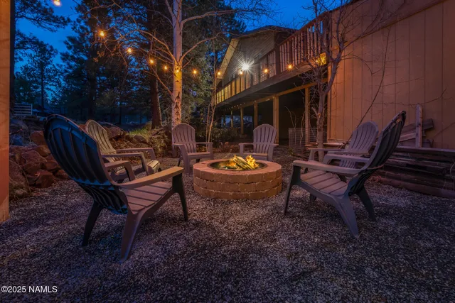 a view of balcony with wooden floor and fence and a large tree