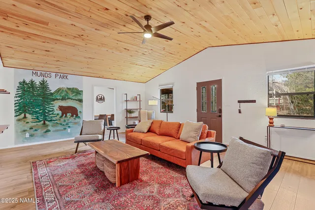 a living room with furniture a rug and a table