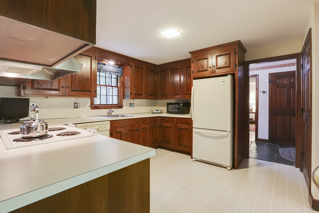18 High Ridge Road Boxford, MA 01921 - Photo 4 of 30 a kitchen with a refrigerator a sink and cabinets
