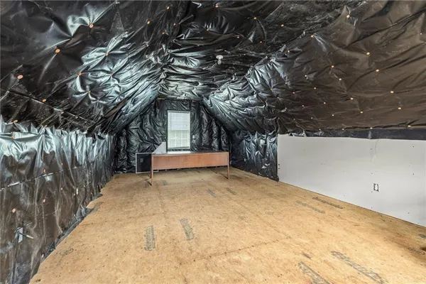 a view of a house with a big yard and large trees