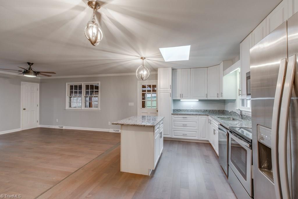 4180 Witherow Road Winston-Salem, NC 27106 - Photo 10 of 24 Lots of counter space with Island which opens into the Den with Fireplace for relaxation