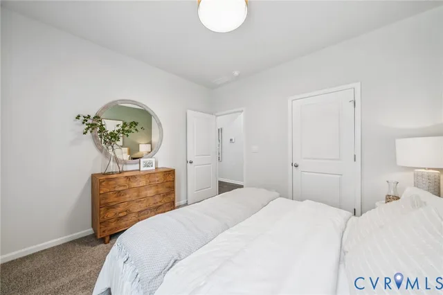 a bedroom with a bed and dresser