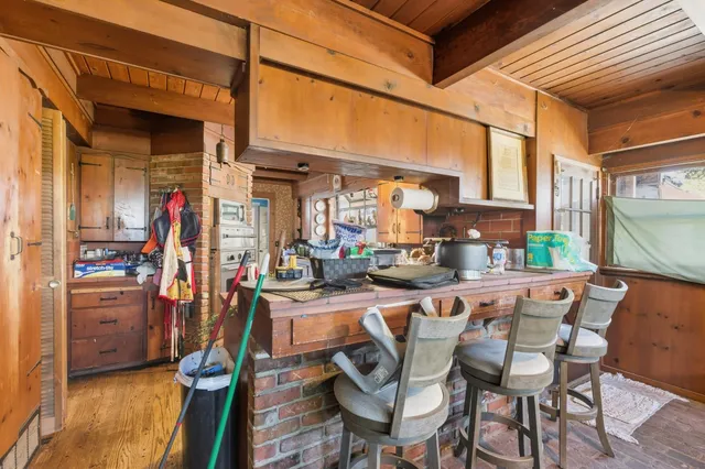 a kitchen with granite countertop a sink stove and cabinets