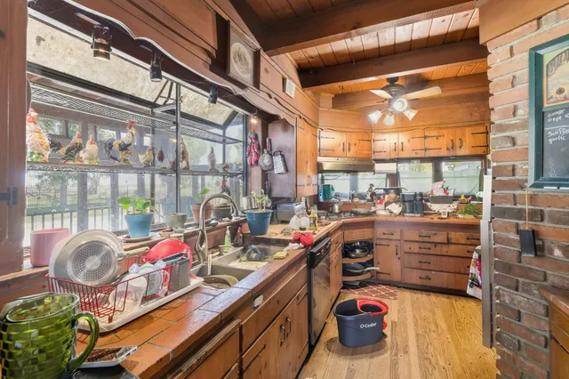 a spacious bedroom with a bed a chandelier and a window