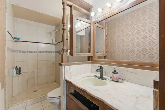 a bathroom with a shower and a sink