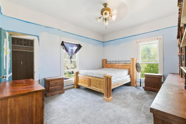 a view of a house with a large window and wooden floor