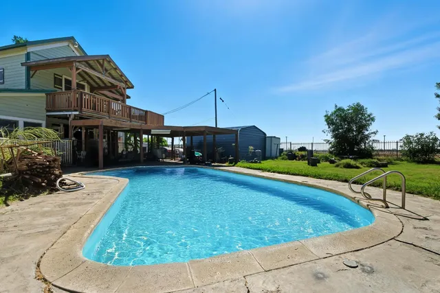 a patio with glass top table and chairs