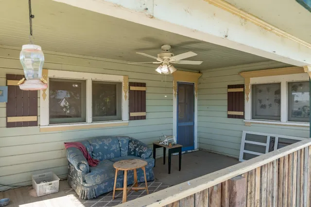 an aerial view of a house with a yard patio and deck