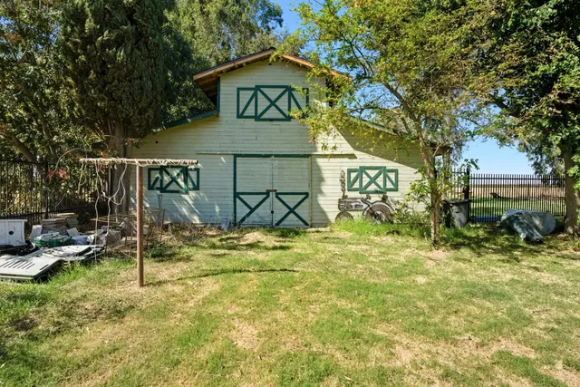 an aerial view of a house with swimming pool and outdoor seating