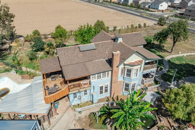 an aerial view of a residential houses with outdoor space