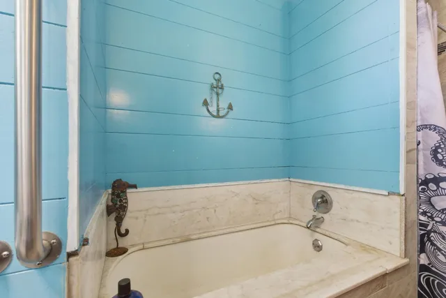 a living room with furniture a flat screen tv and a table