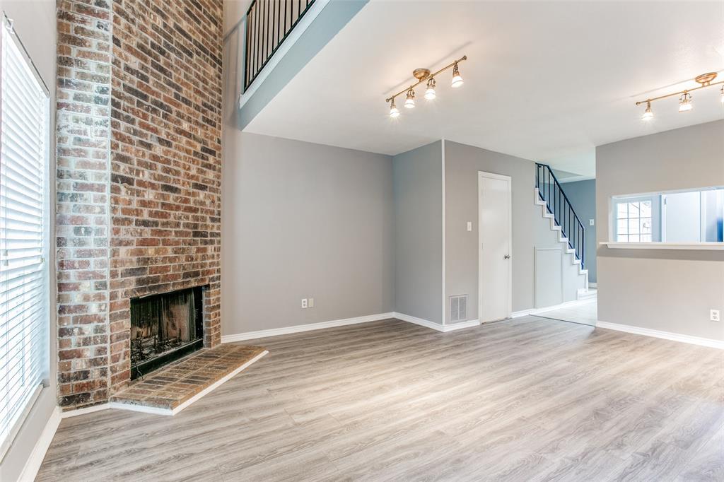 12 Abbey Road Euless, TX 76039 - Photo 3 of 12 iving room featuring light wood-style floors and a fireplace