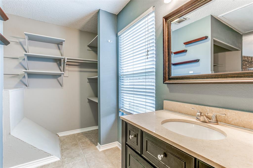 12 Abbey Road Euless, TX 76039 - Photo 10 of 12 Full bathroom featuring vanity and a walk in closet with washer and dryer space as well