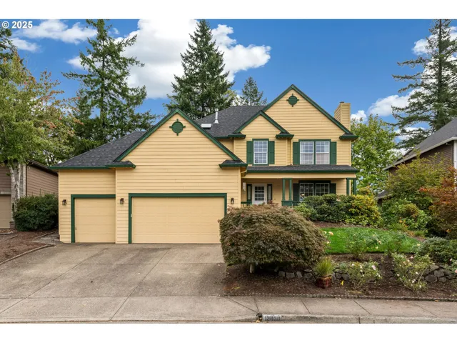 a view of a house with a yard and garage