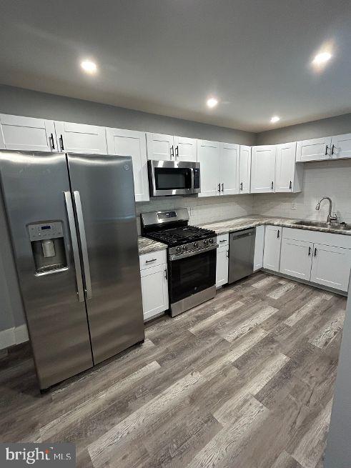 1116 Sanger Street Philadelphia, PA 19124 - Photo 15 of 47 a kitchen with stainless steel appliances granite countertop a stove a sink and a refrigerator