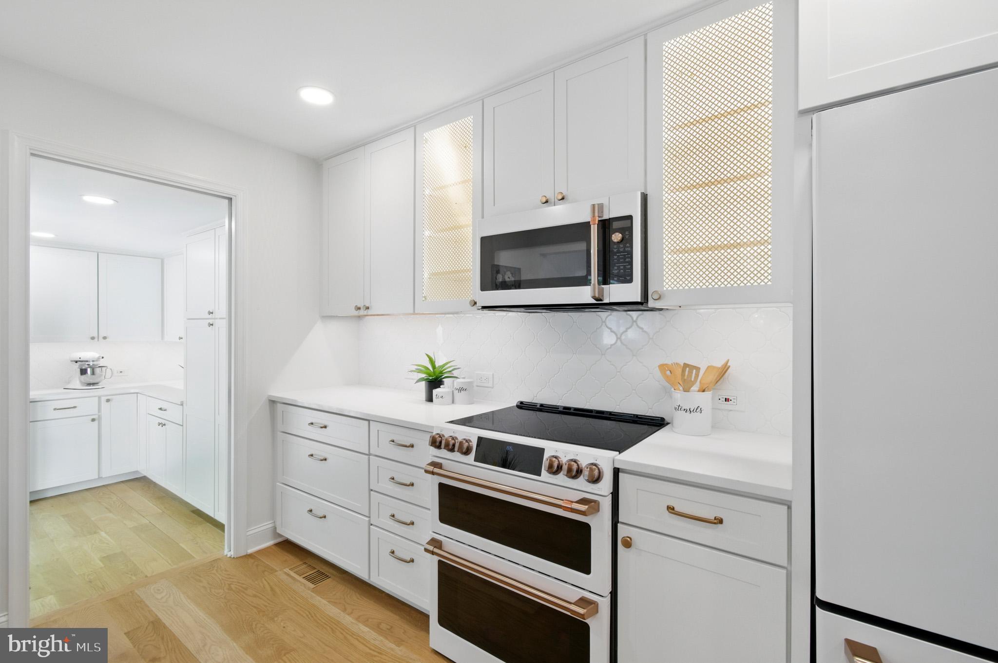 3633 Valley Road Ellicott City, MD 21042 - Photo 21 of 72 a kitchen with stainless steel appliances white cabinets and a stove top oven
