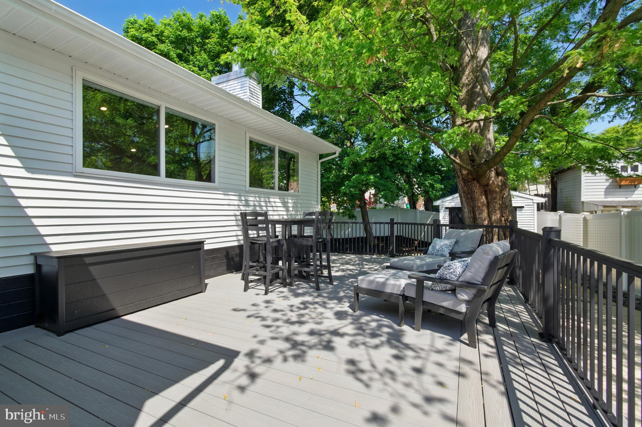 3633 Valley Road Ellicott City, MD 21042 - Photo 54 of 72 a view of a patio with a dining table and chairs with wooden floor